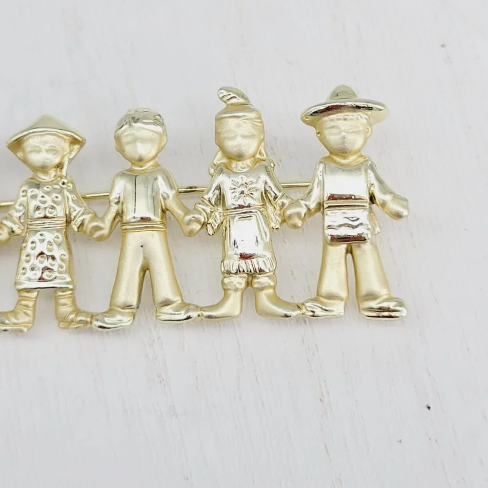 AJC American Jewelry Co. Children Of The World Brooch Satin & Polished Gold Tone
